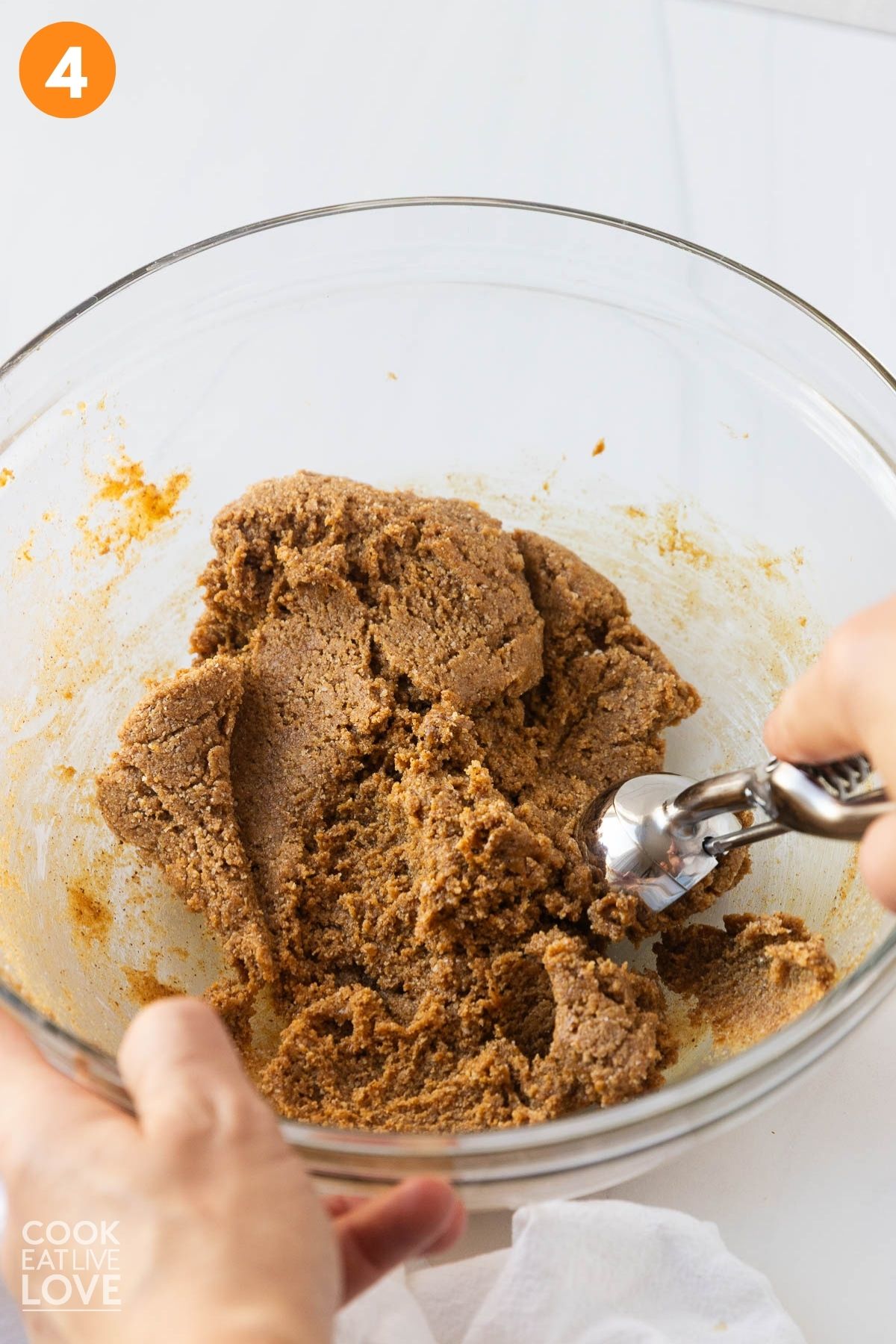 Using the cookie scoop to portion the mixture.