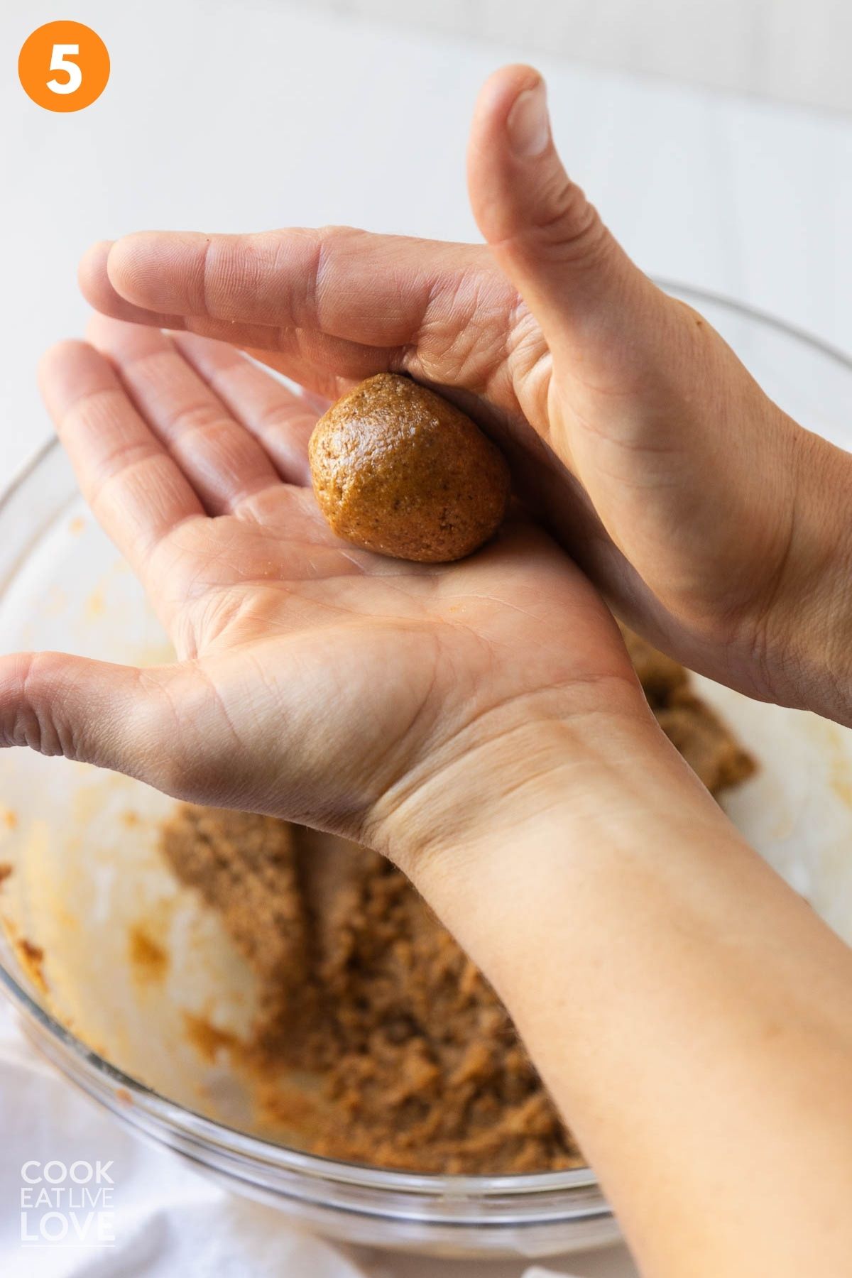 Rolling the mixture into balls.