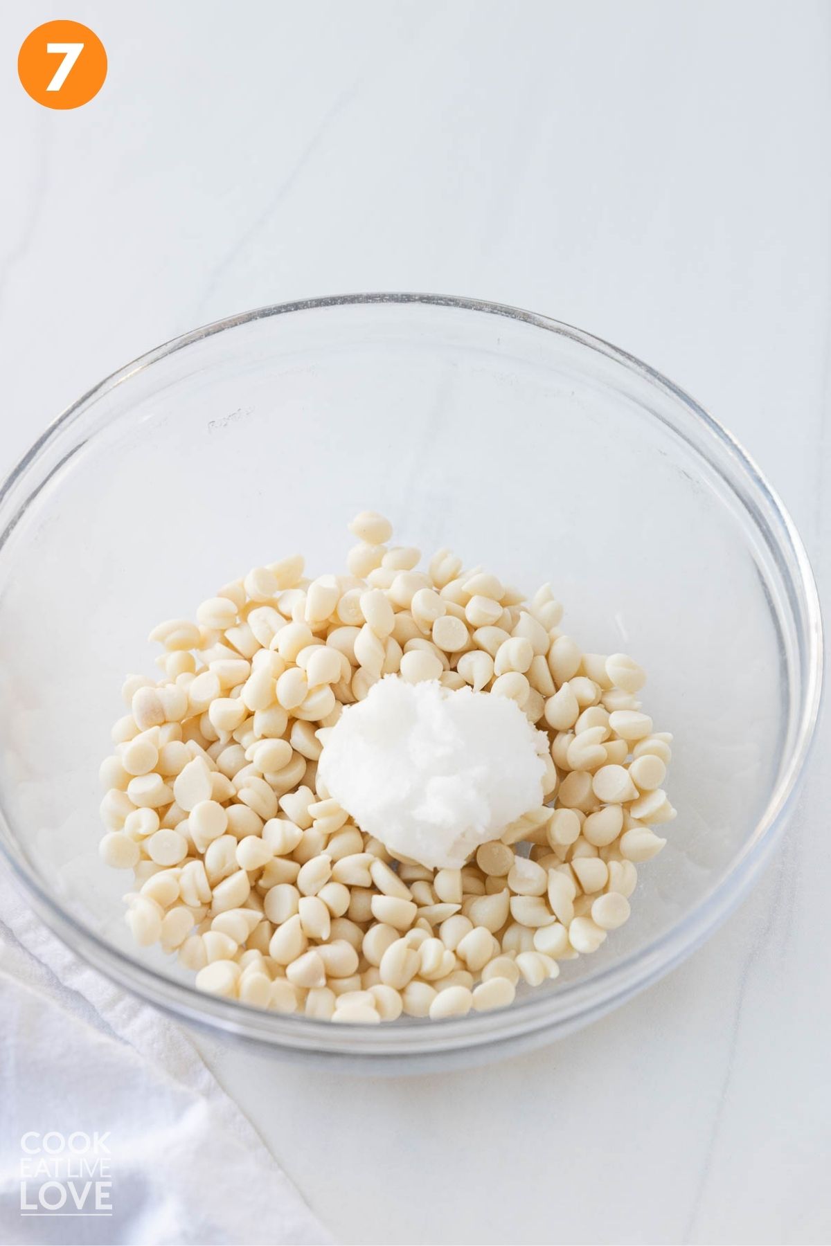 White chocolate chips and coconut oil to a microwave-safe dish to melt.