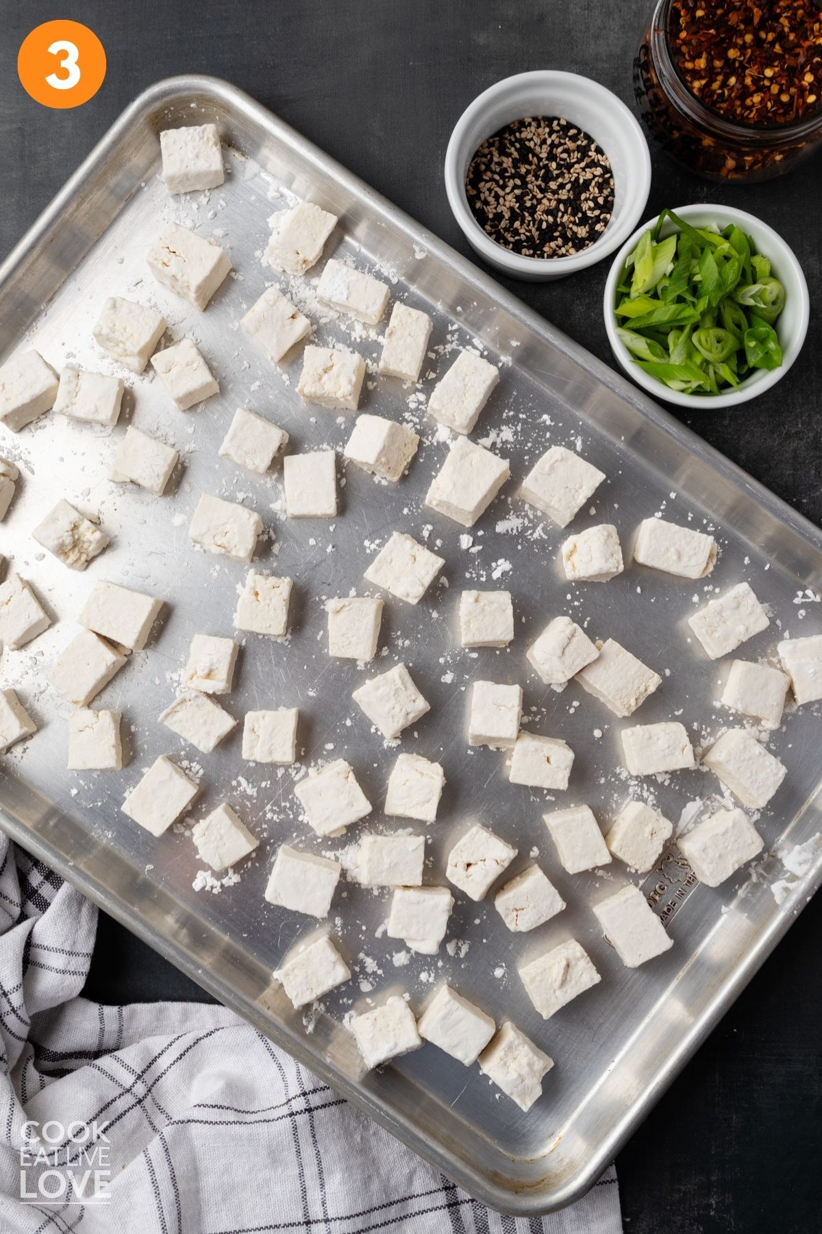 Coated tofu on a baking sheet.