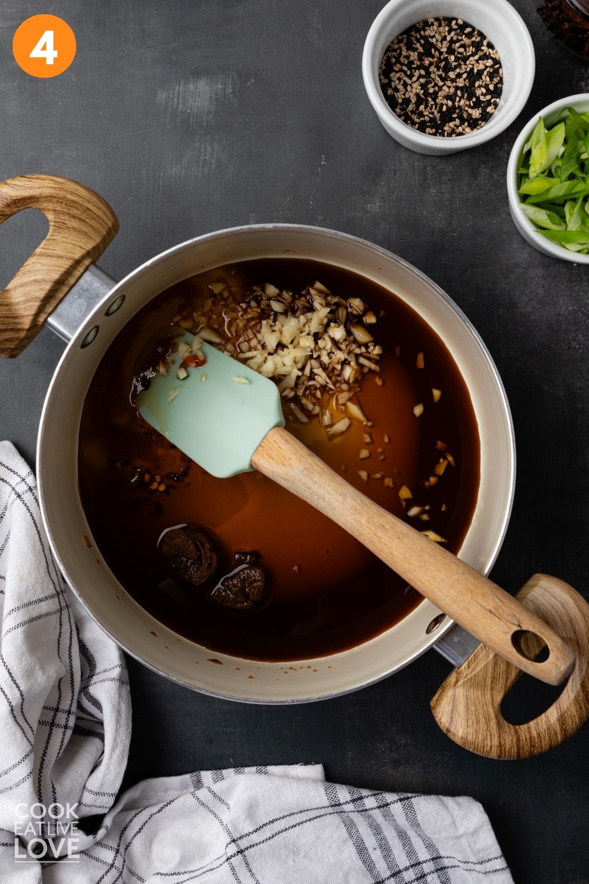 Soy sauce, garlic, honey, sesame oil, miso, sriracha, rice vinegar, and red pepper flakes in a small pot.