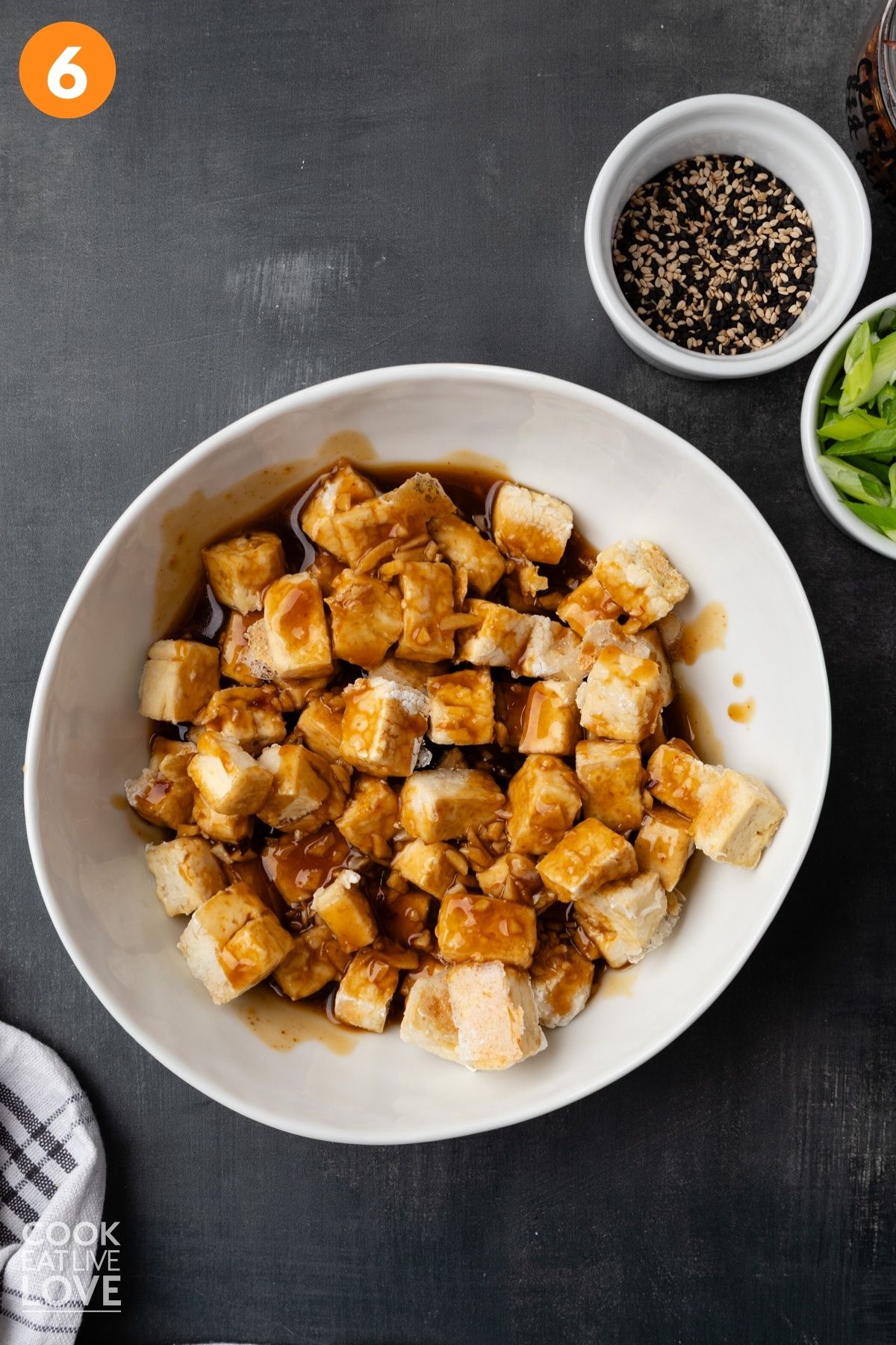 Sauce coating the tofu in a bowl.