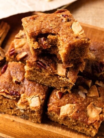 Pumpkin blondies on a wooden plate.