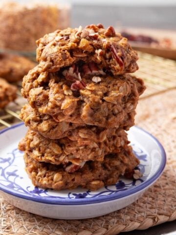 Pumpkin oatmeal cookies stacked on a plate.