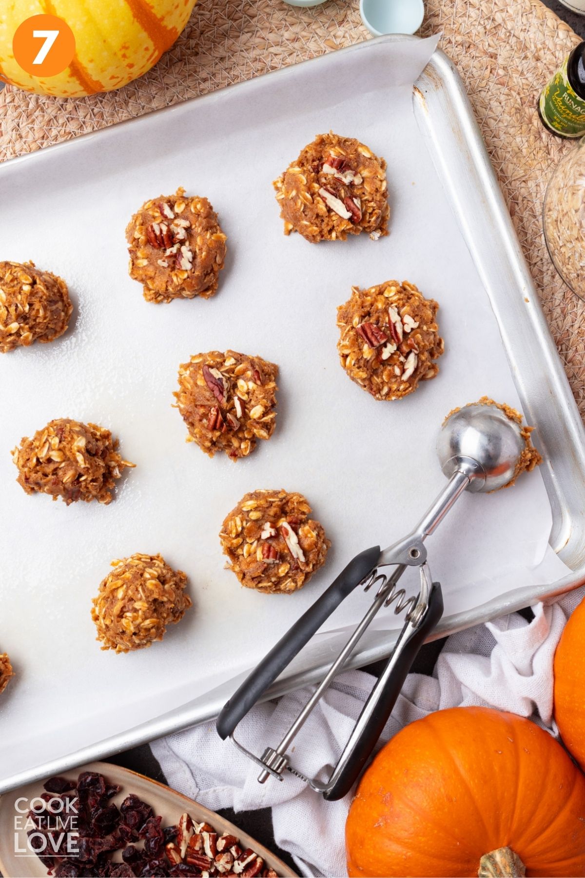 Cookie being flattened on to a baking sheet.