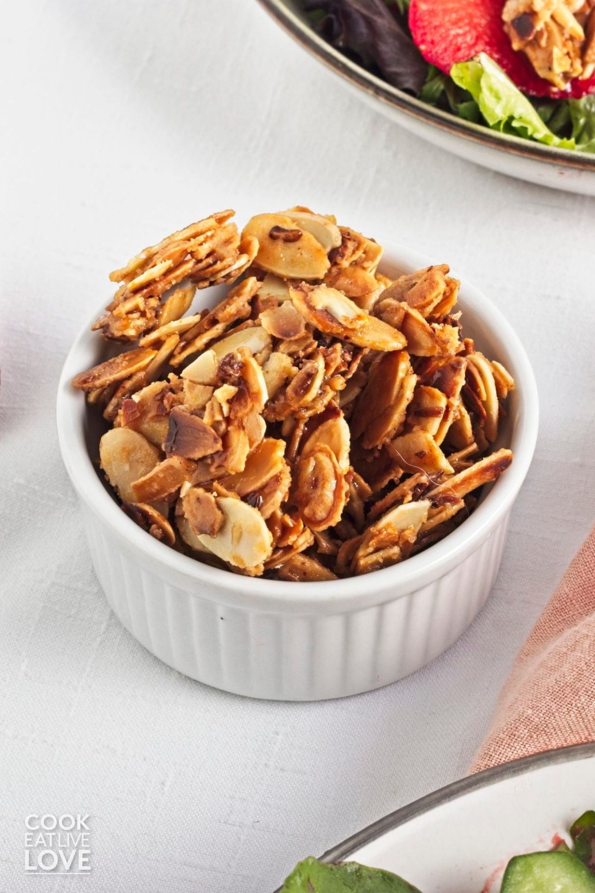 A bowl of spiced almonds on a table. 
