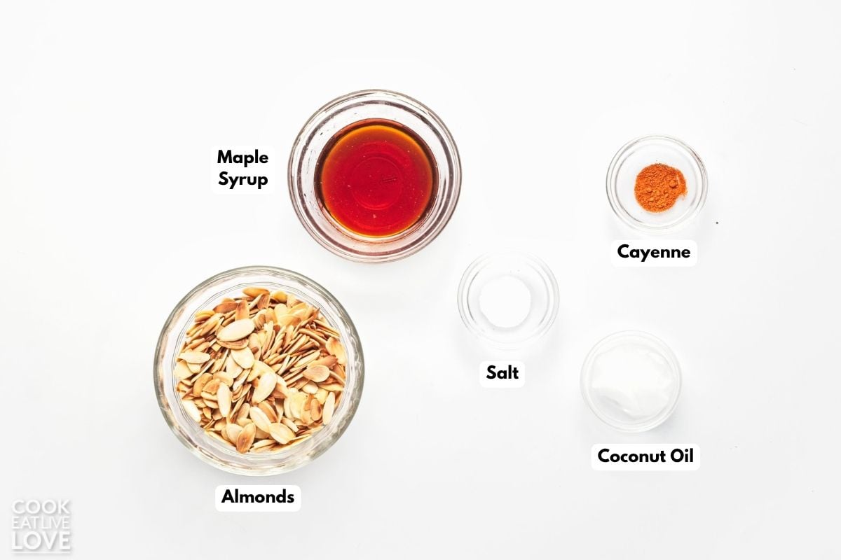 Ingredients to make spiced almonds on the table in bowls. 
