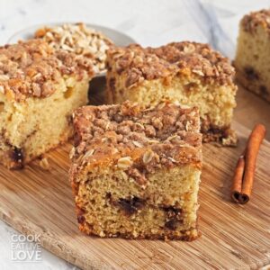 Pieces of vegan coffee cake on a wooden board.
