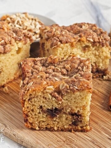 Pieces of vegan coffee cake on a wooden board.