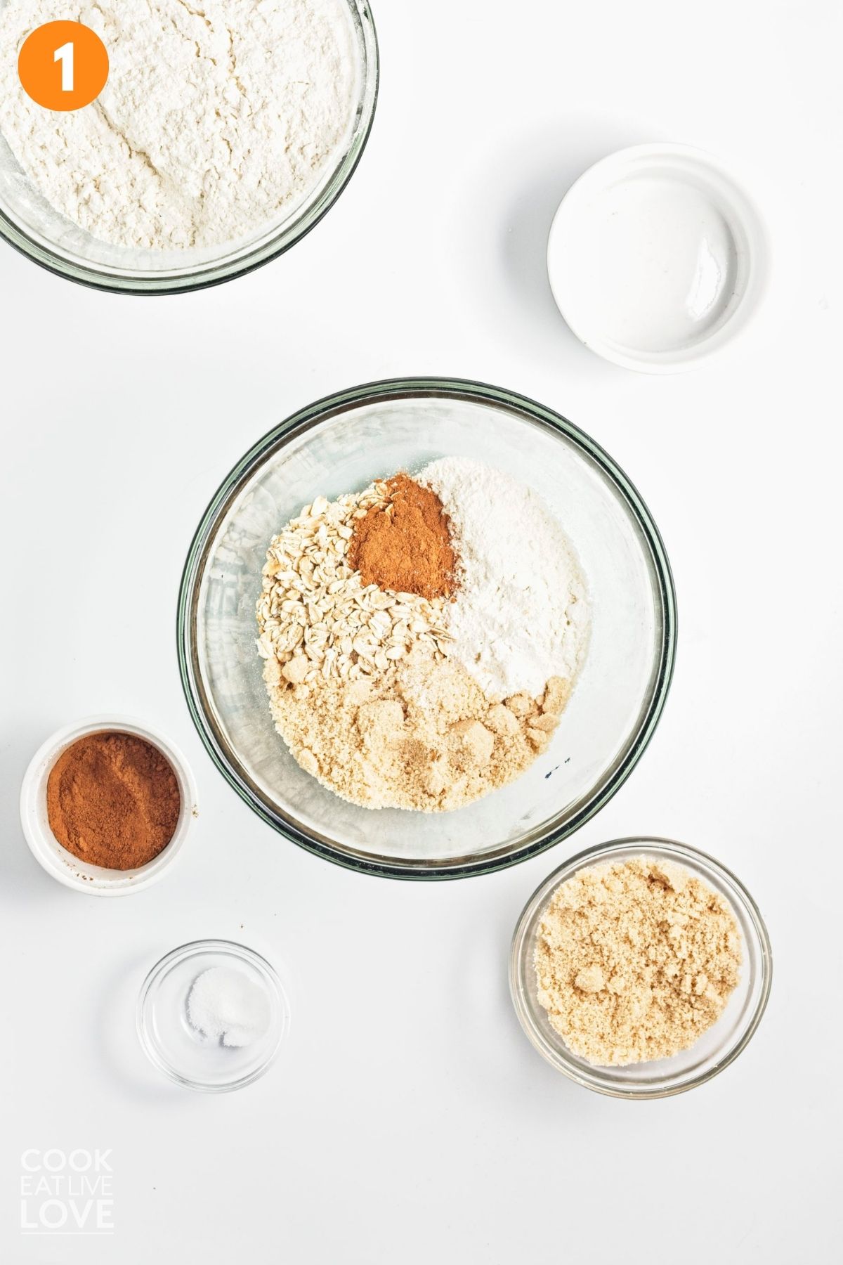 Sugar, oats, flour, and cinnamon combined in a small bowl.