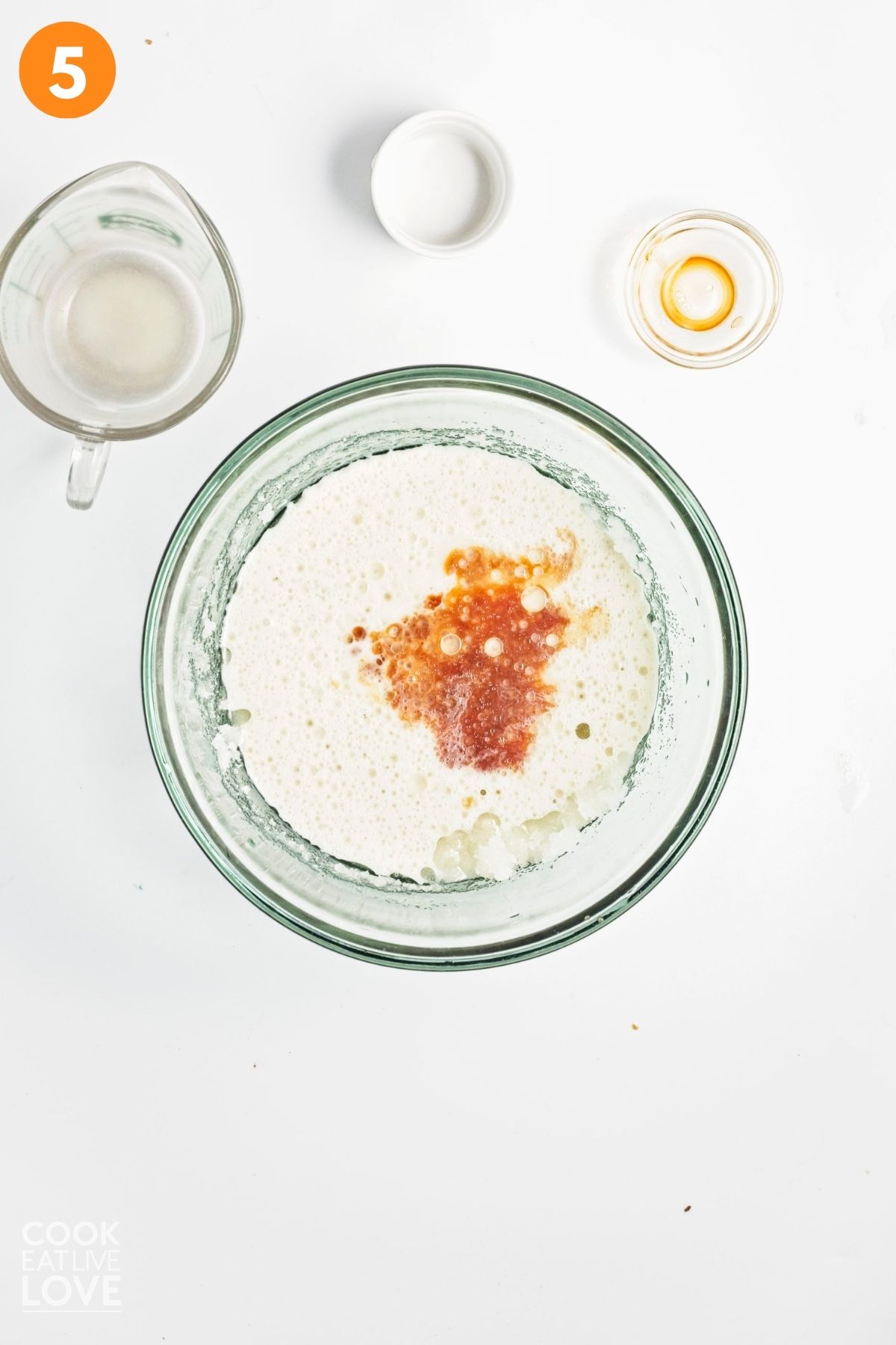 Milk, vinegar, and vanilla extract added to the sugar and oil blend.