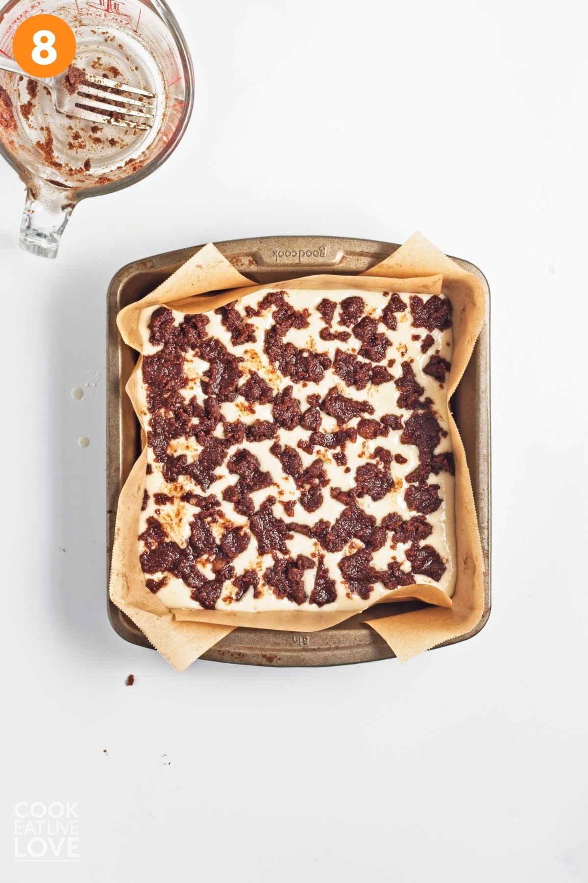 Cinnamon paste spread over the batter.