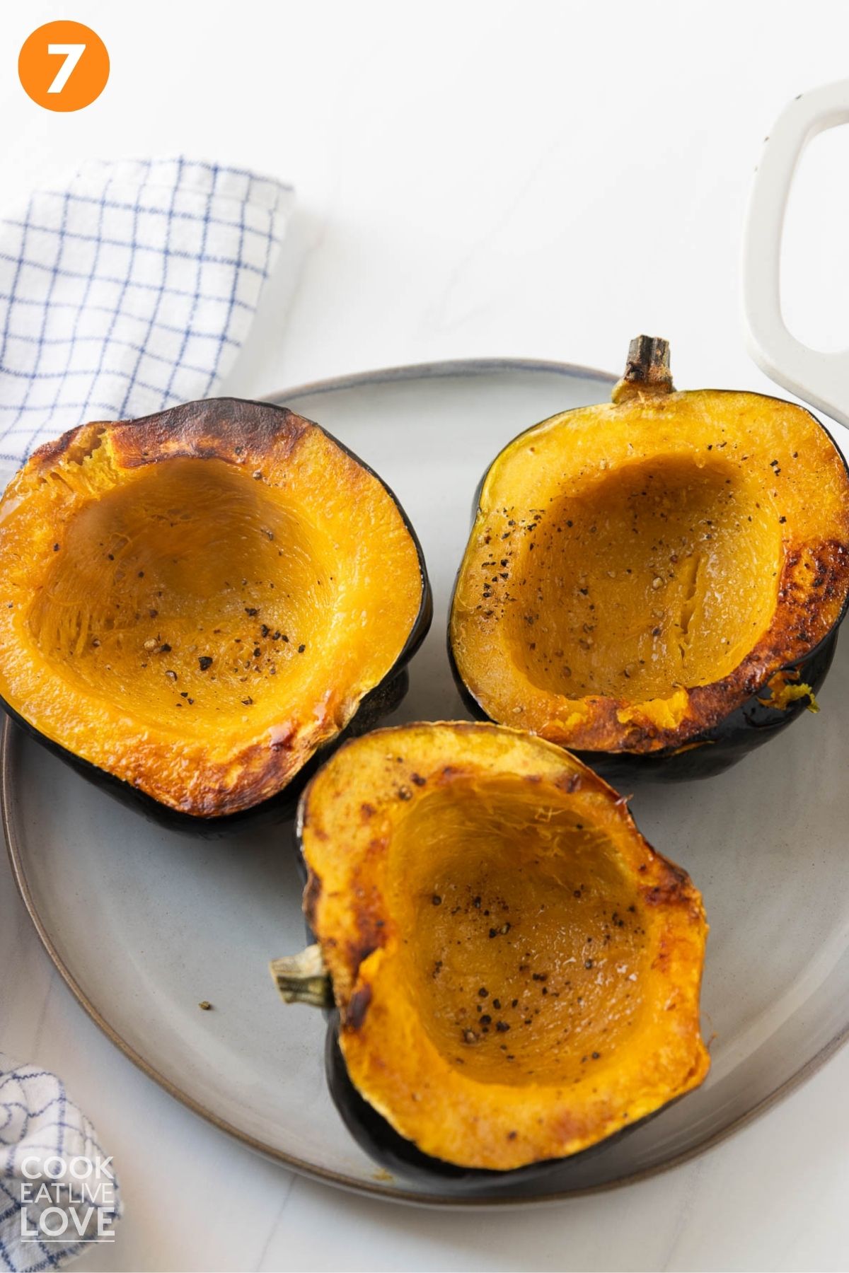 Cooked acorn squash on a plate. 