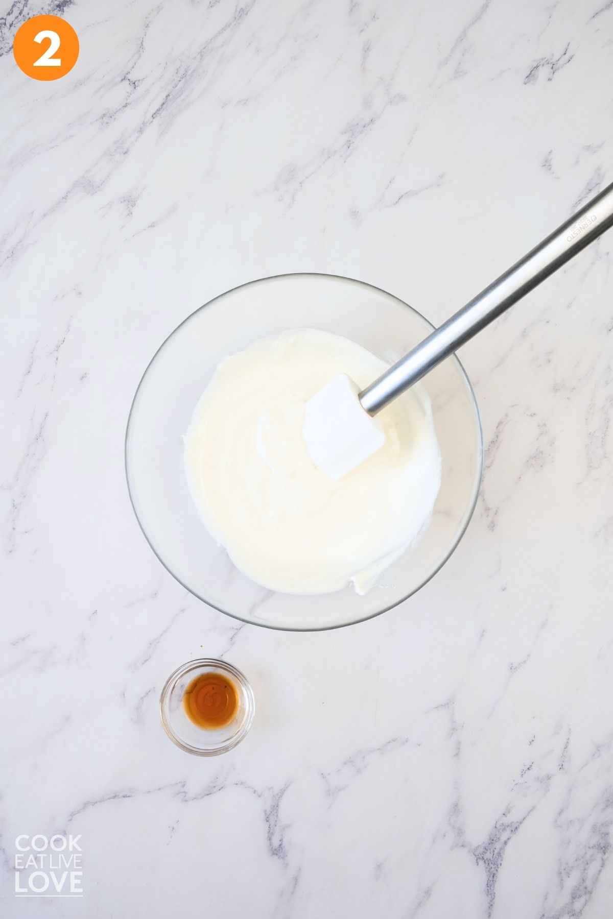 Powdered sugar and sour cream mixed together in a bowl.