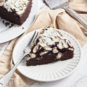 A slice of chocolate olive oil cake on a plate.
