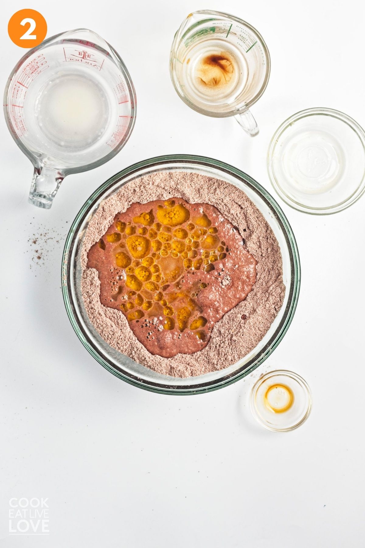 Milk, coffee, oil, and vanilla extract put into the center of the dry ingredients.