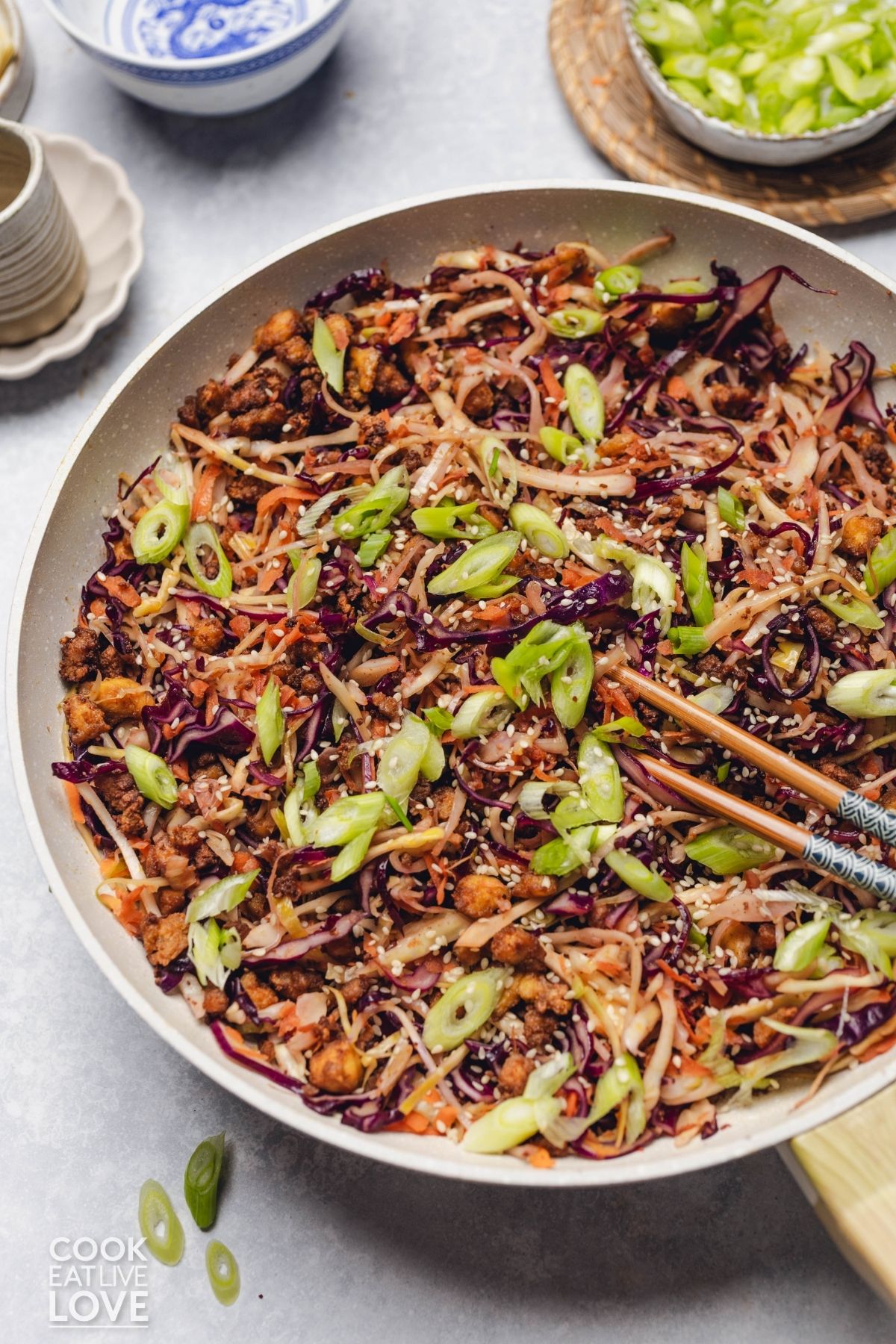 Egg roll in a bowl in a skillet. 