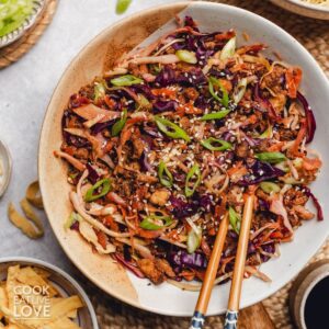 Vegetarian egg roll in a bowl with chopsticks.