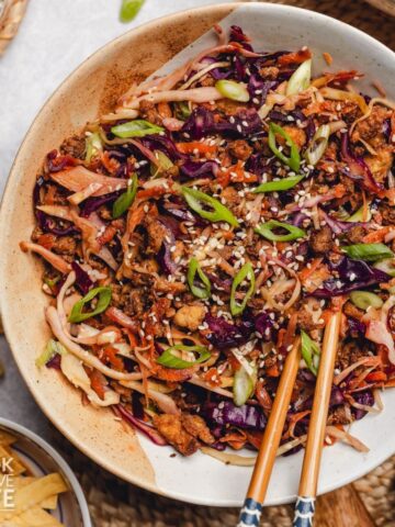 Vegetarian egg roll in a bowl with chopsticks.