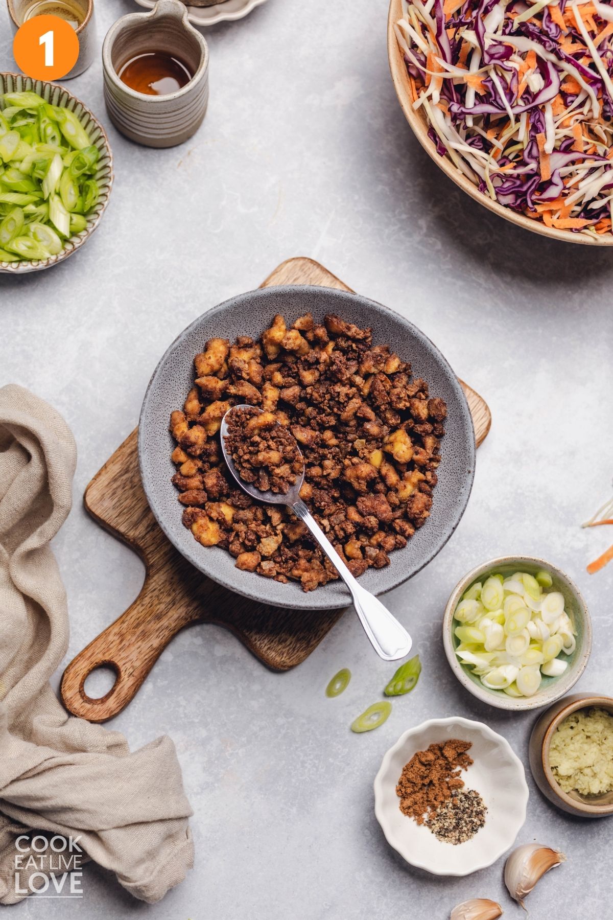 Ground tofu crumbles in a pan.
