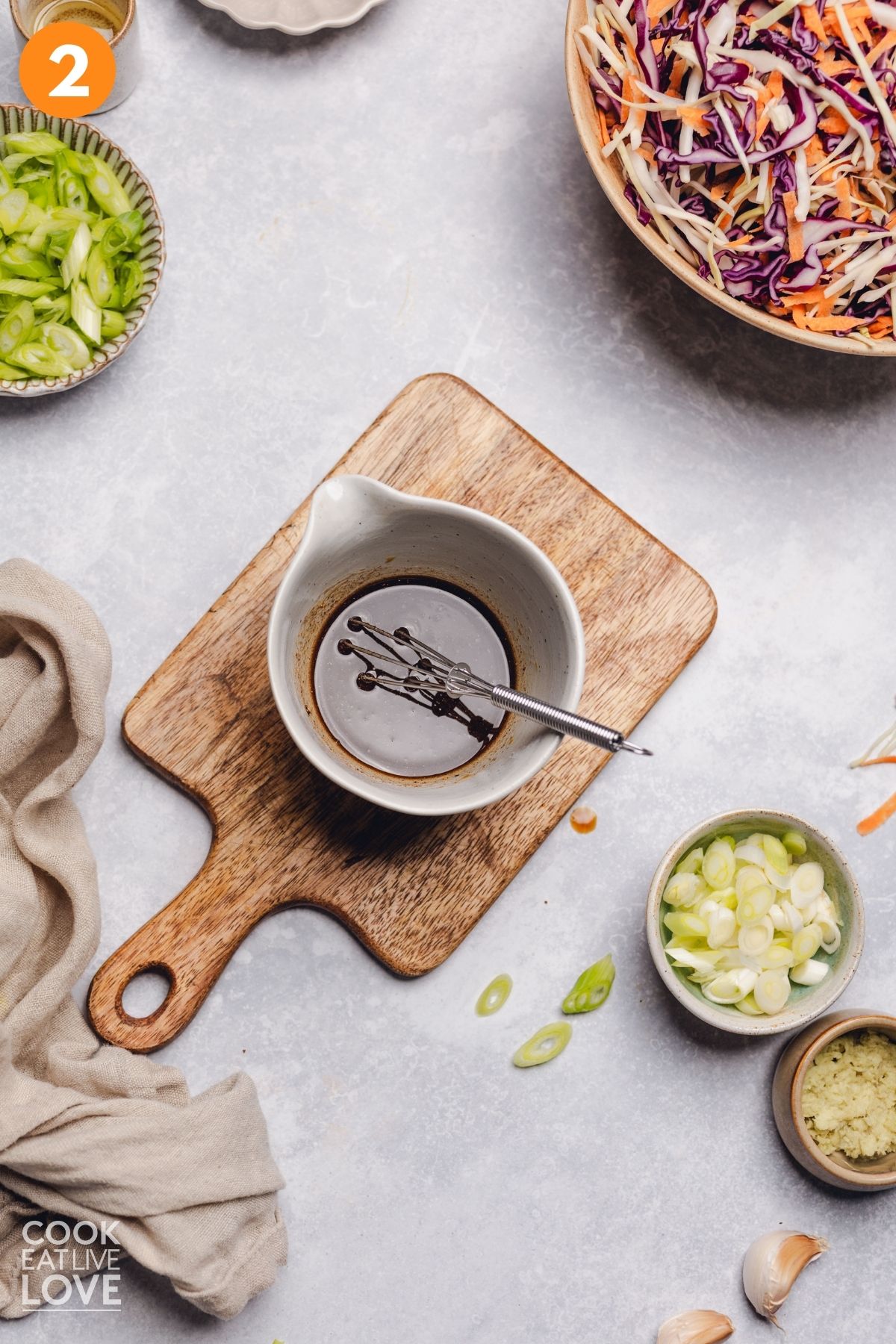 Soy sauce, vinegar, sesame oil, pepper, and five-spice mixed in a bowl.