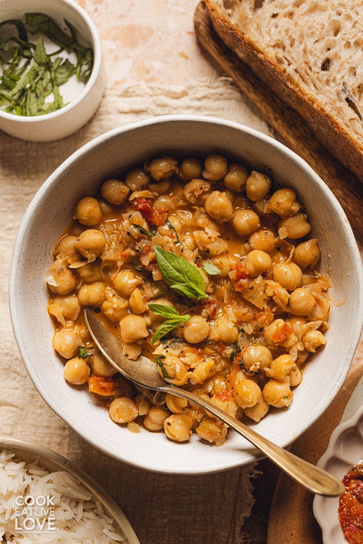 A bowl of marry me chickpeas on a table. 