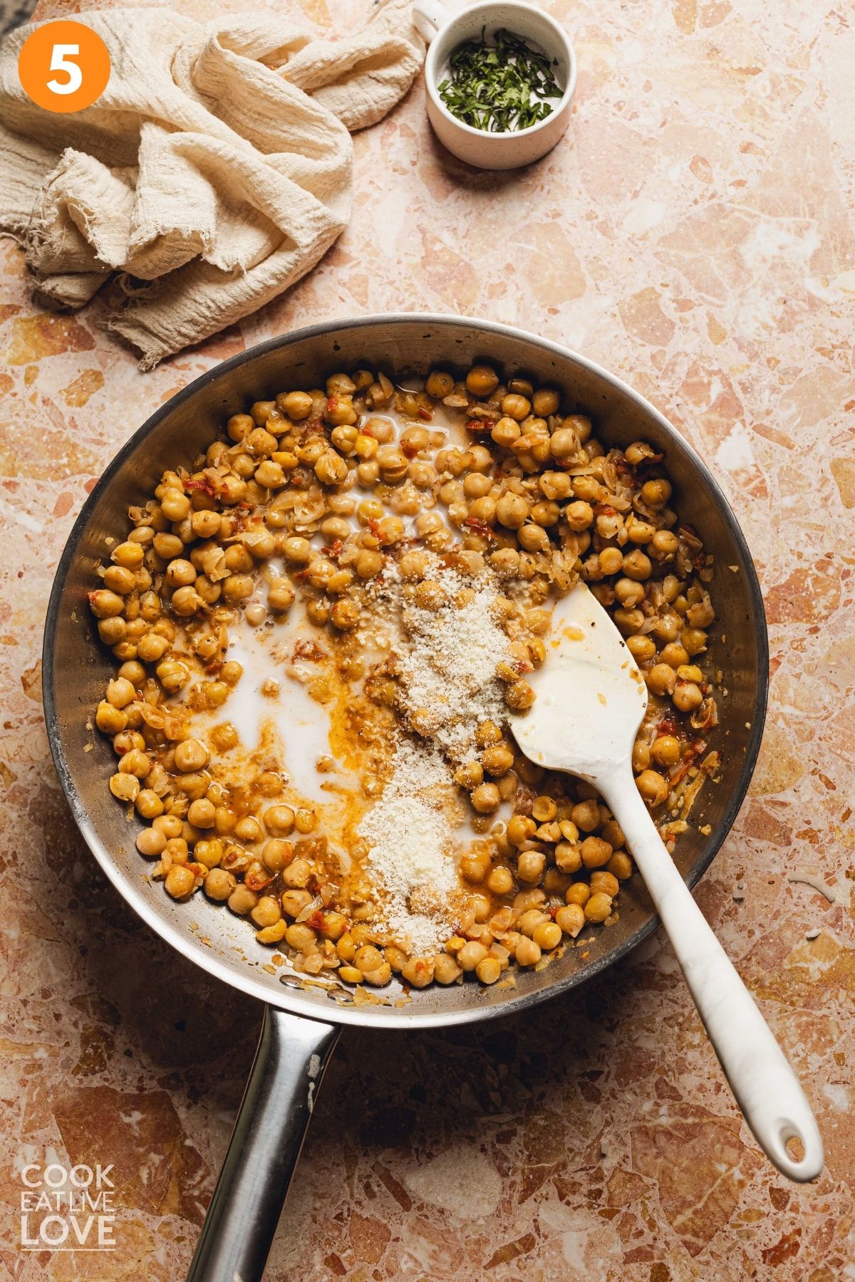 Half-and-half and parmesan cheese added to the skillet.