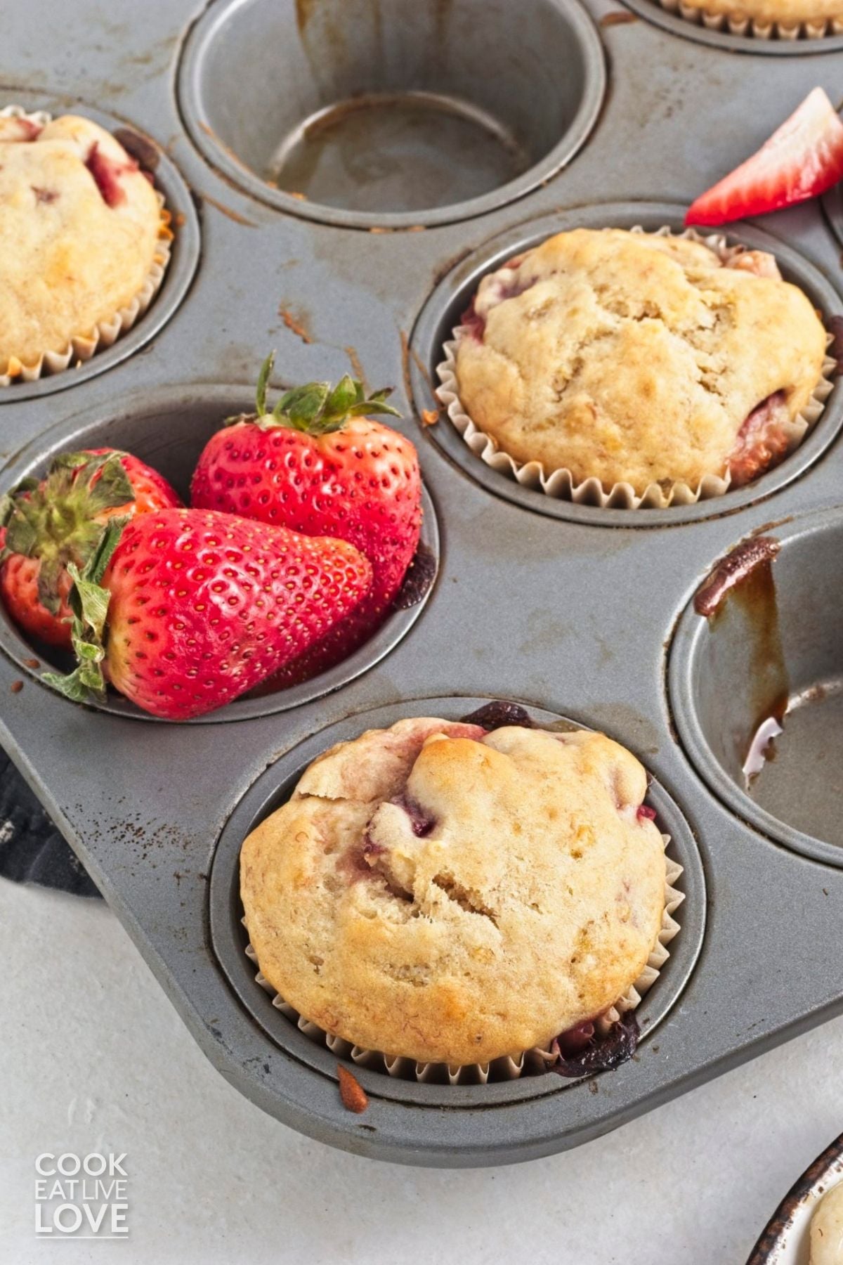 Strawberry banana muffins in a muffin tin.