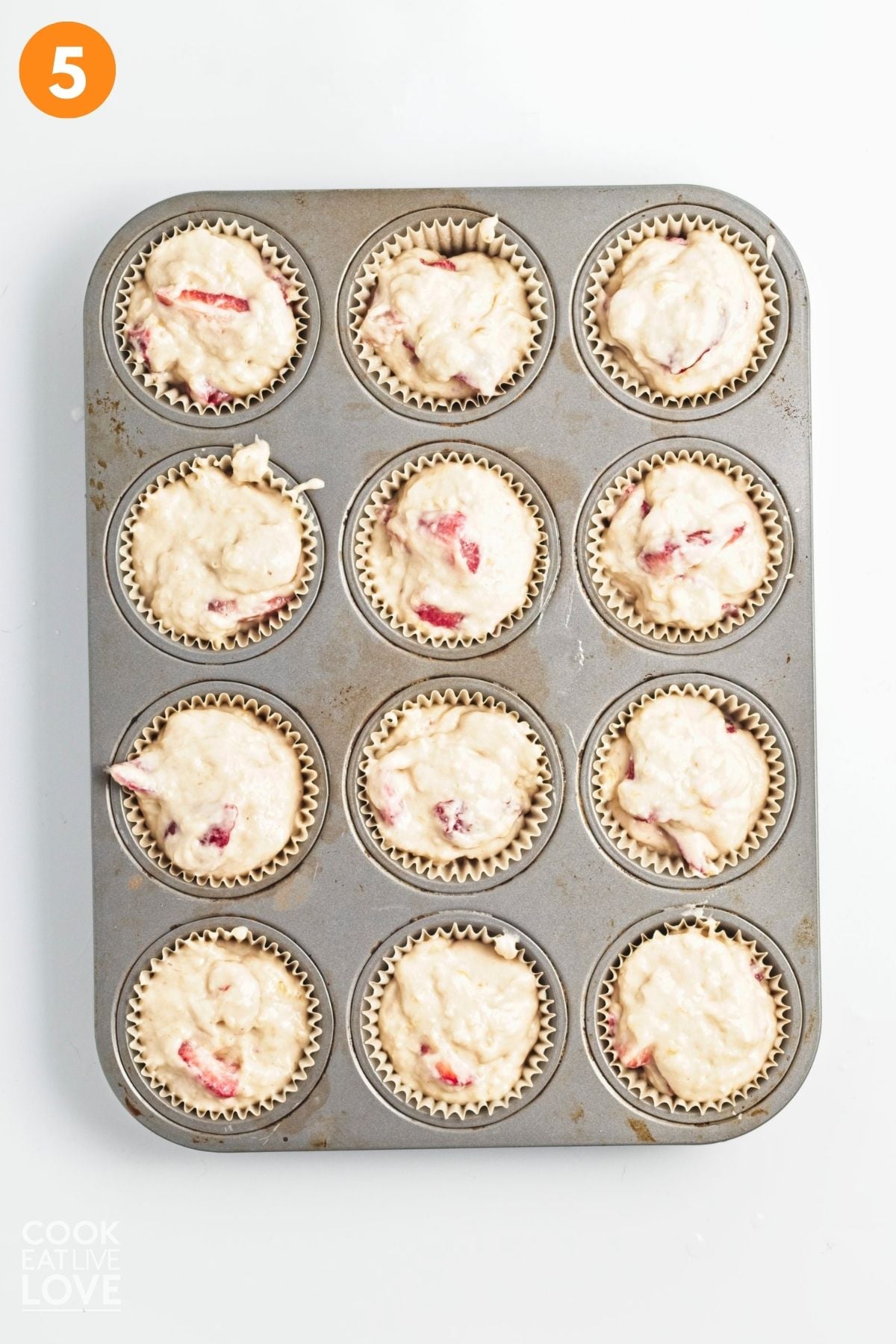 The strawberry and banana muffin mixture put into the prepared muffin tin.