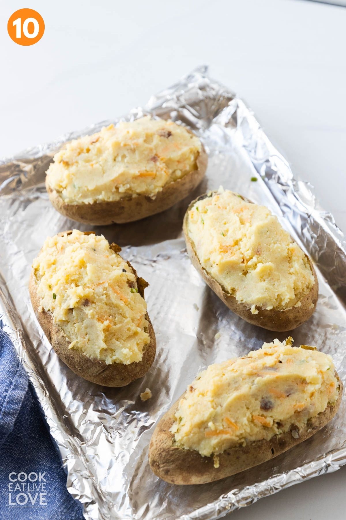 Potato filling added to the scooped out skins. 