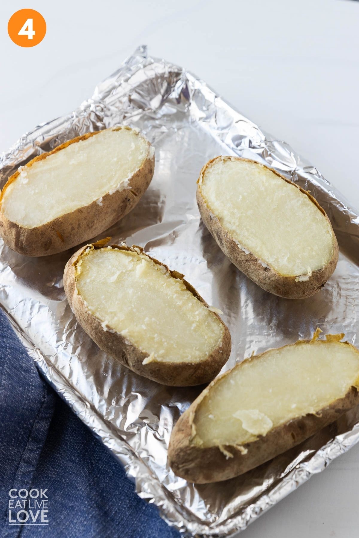 Baked potatoes with tops cut off. 