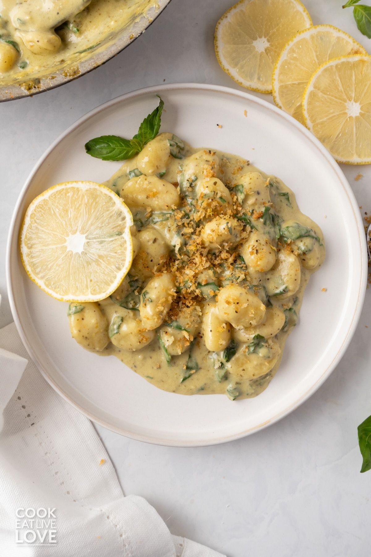 Creamy pesto gnocchi on a plate.