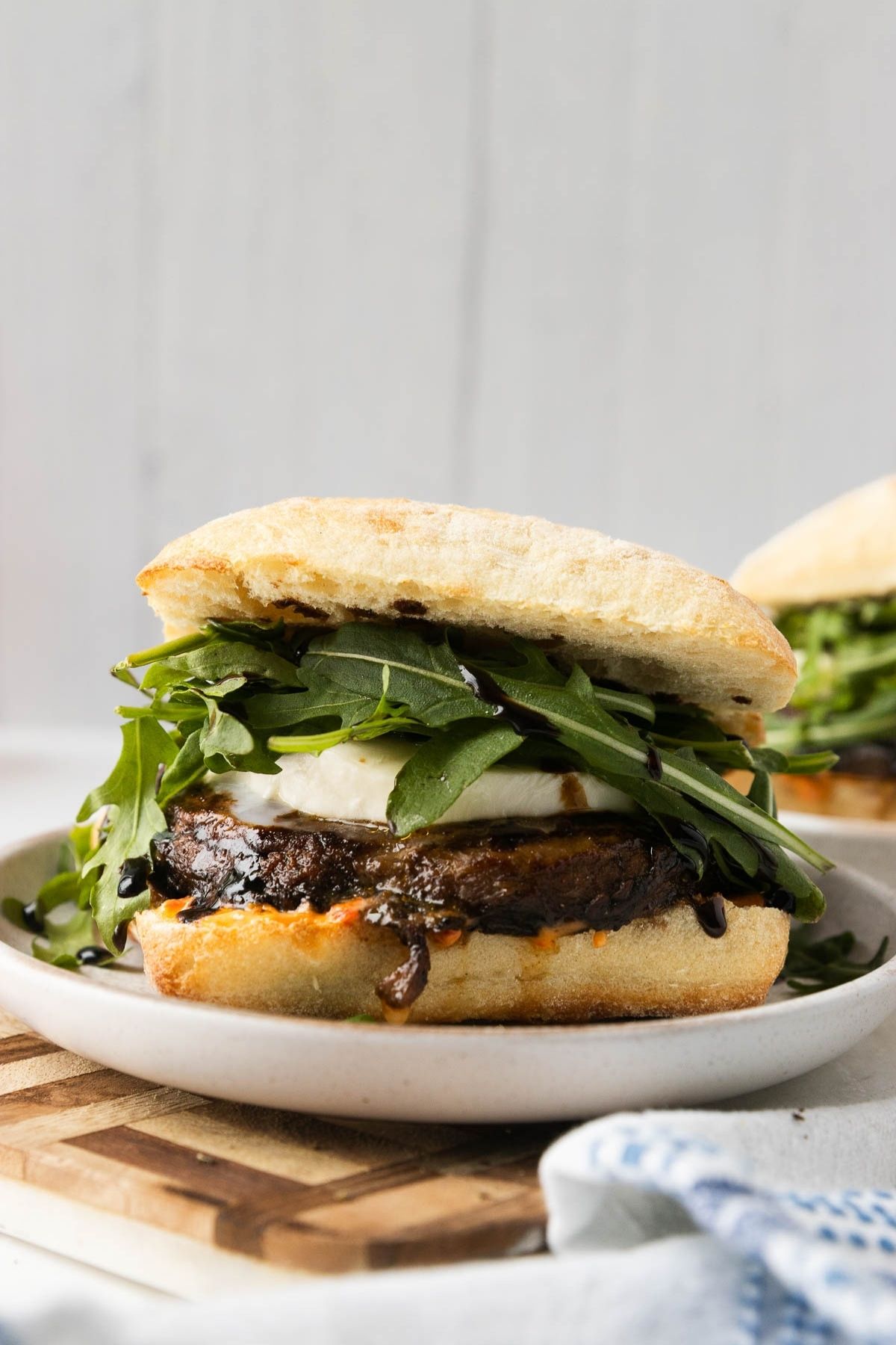A plate with a portobello mushroom sandwich on it.
