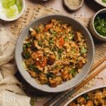 A gray bowl filled with fried rice and tofu.