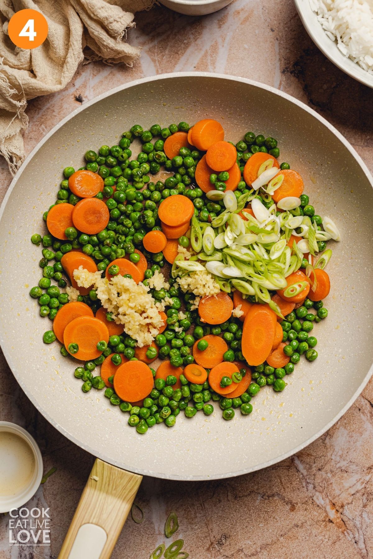 Scallions and garlic added to the peas and carrots.