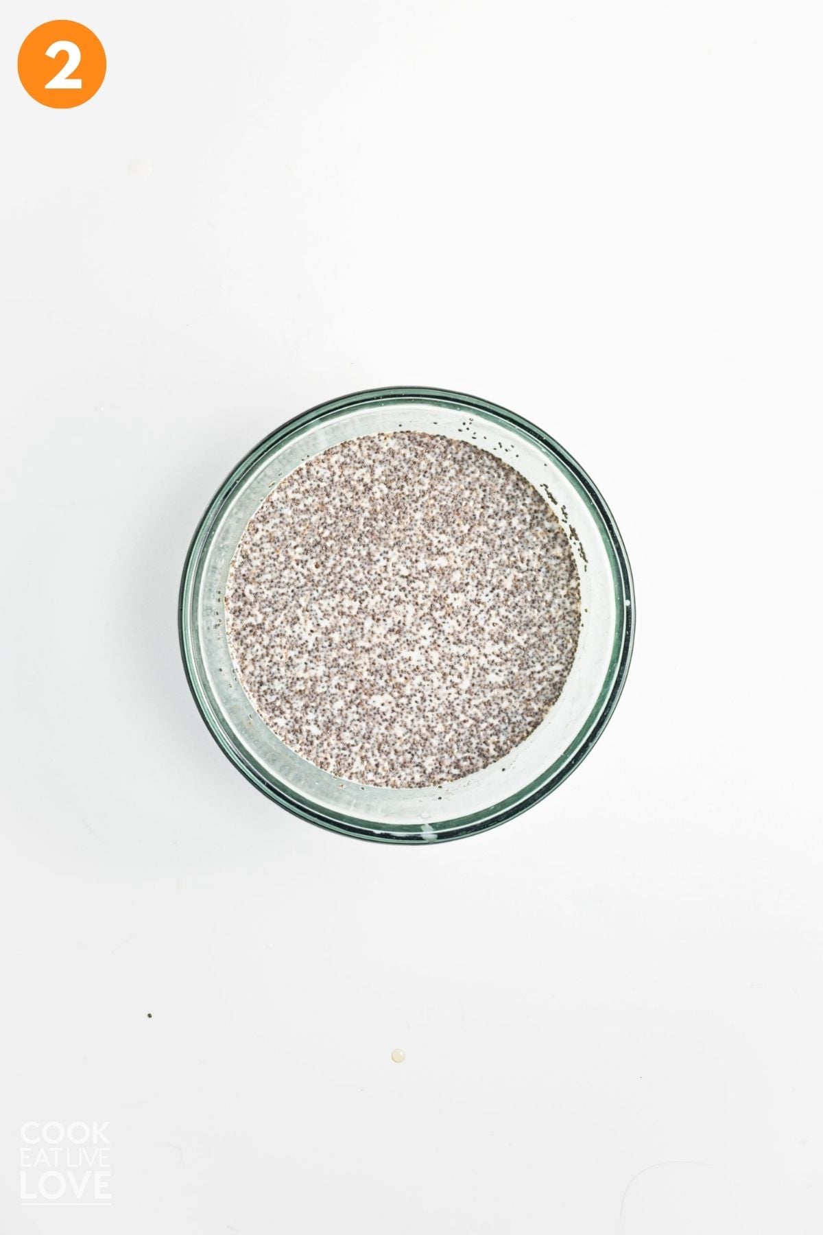 Chia seeds stirred into oat milk.