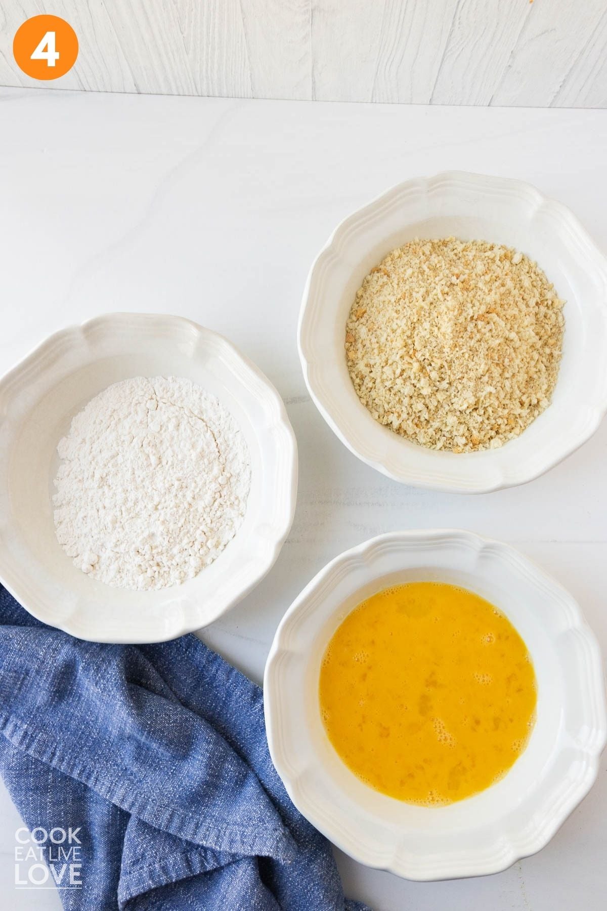 Bowls with eggs, panko, and flour for breading the tofu. 