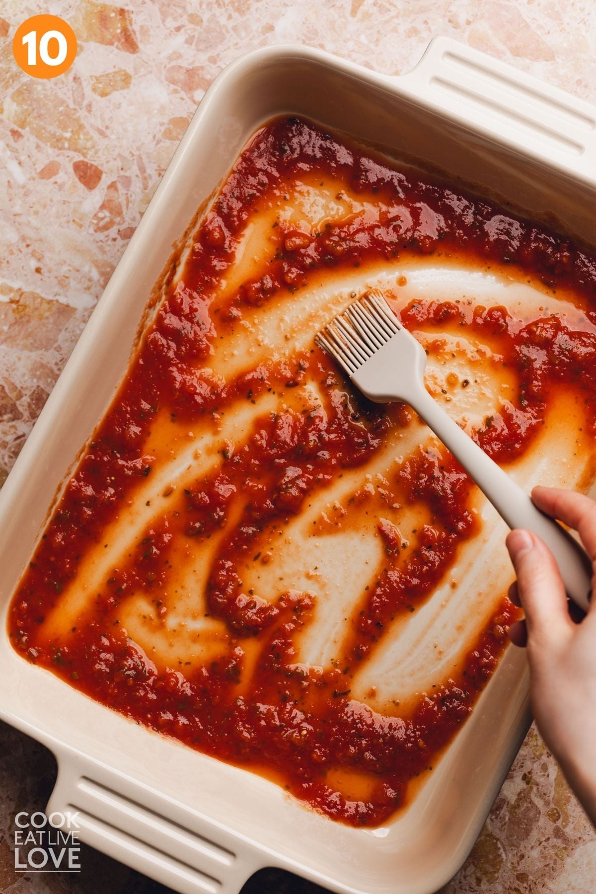 Sauce spread in a baking dish.