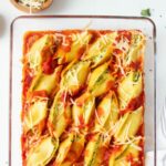 Pinterest graphic with image of stuffed shells and text on top.