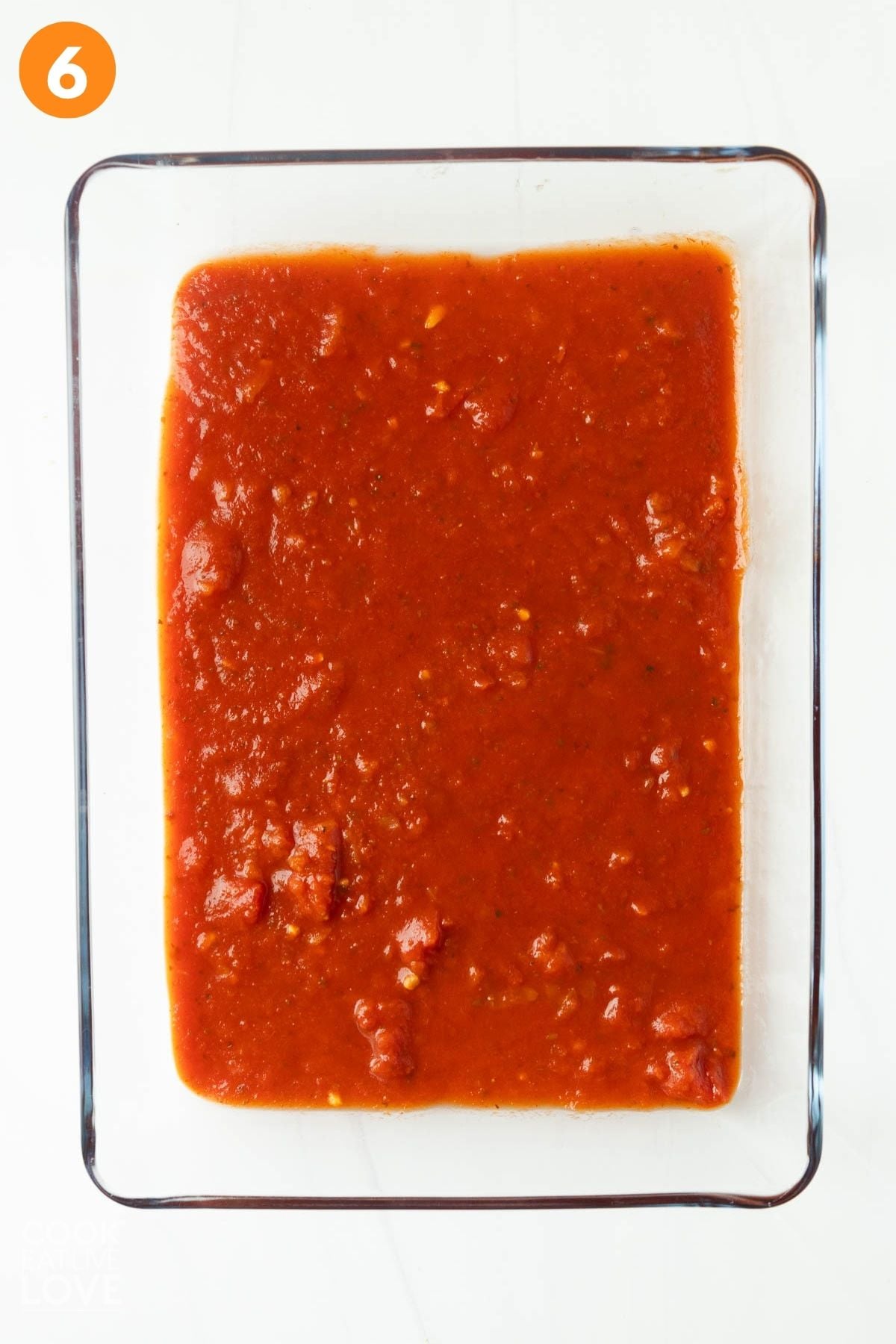 Marinara sauce added to the baking dish. 
