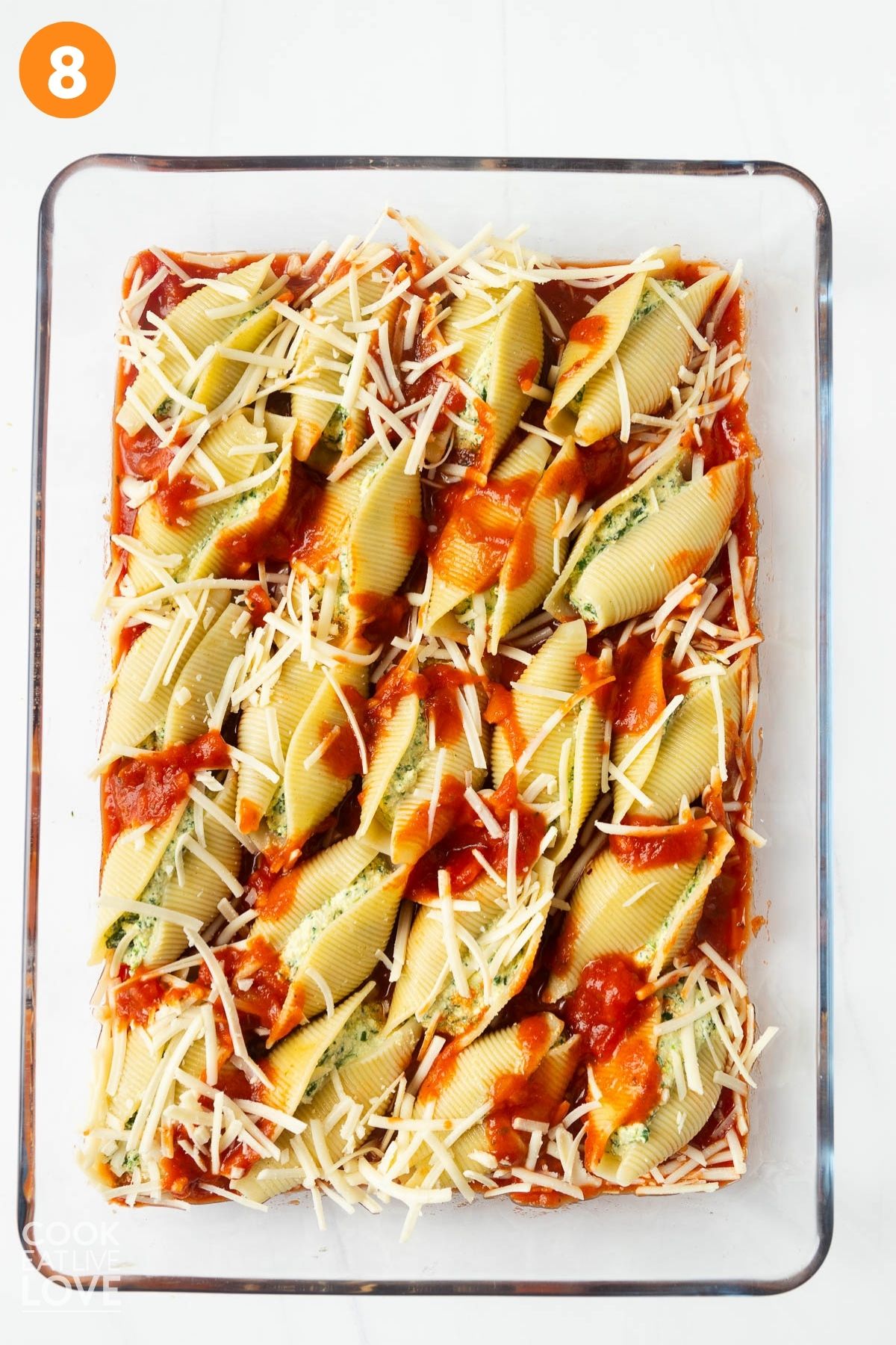 Marinara sauce and cheese sprinkled over the top of the vegan shells. 