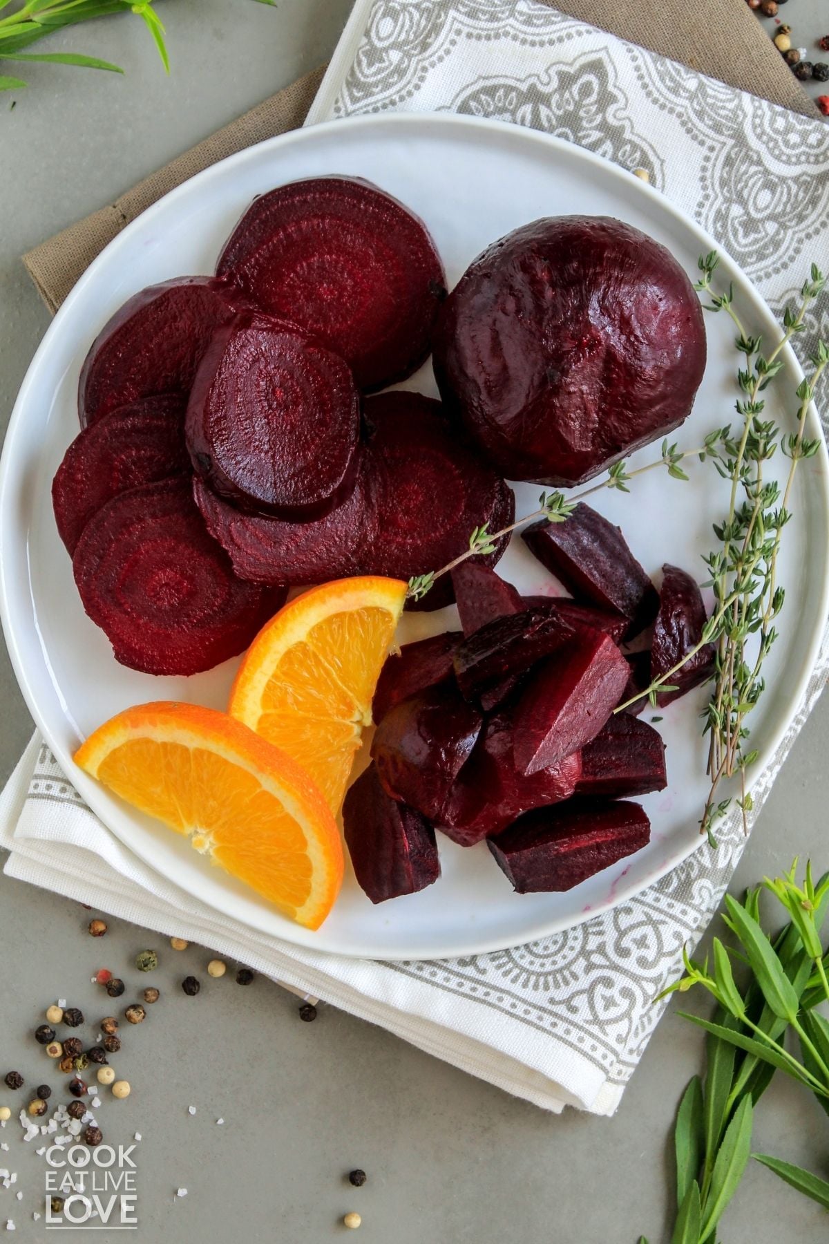 Roasted beets o a plate with some sliced and some cubed. 