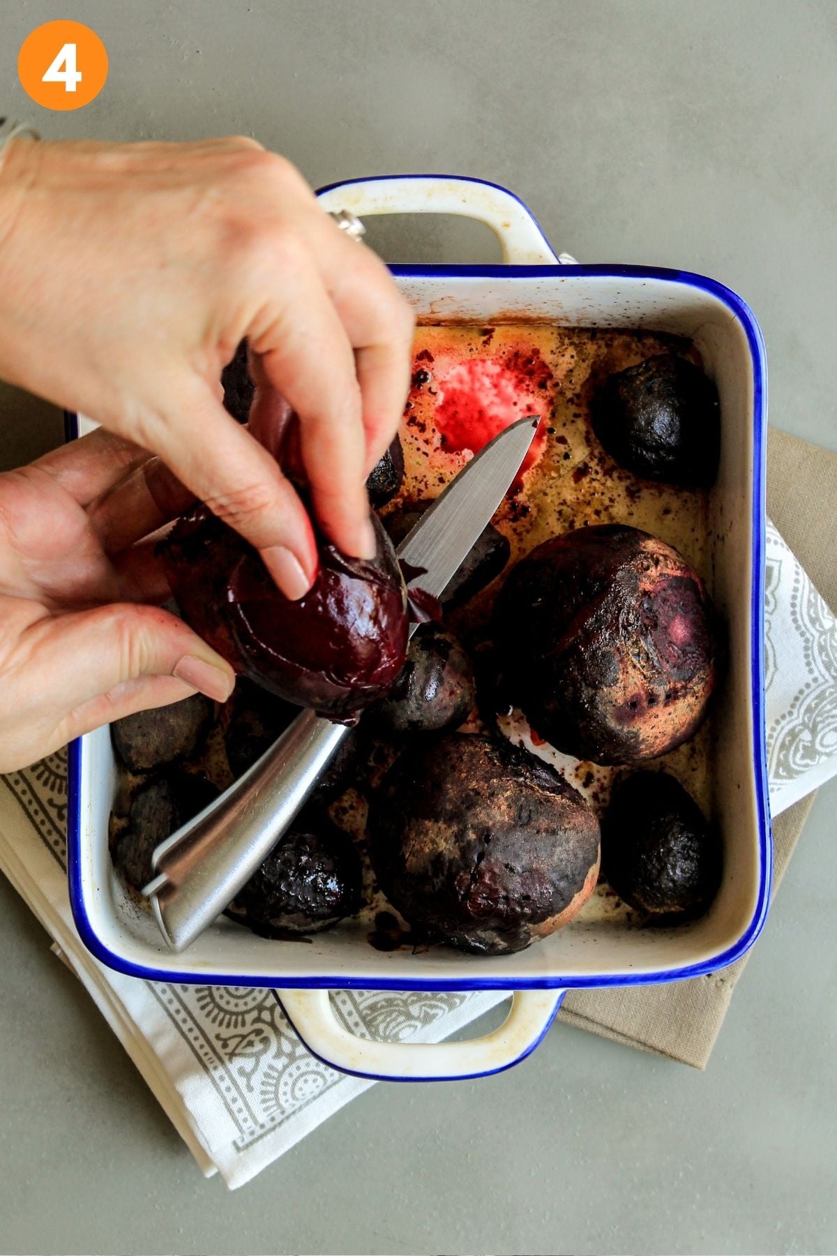 Peels of whole beets rubbed off with fingers after cooking and cooling