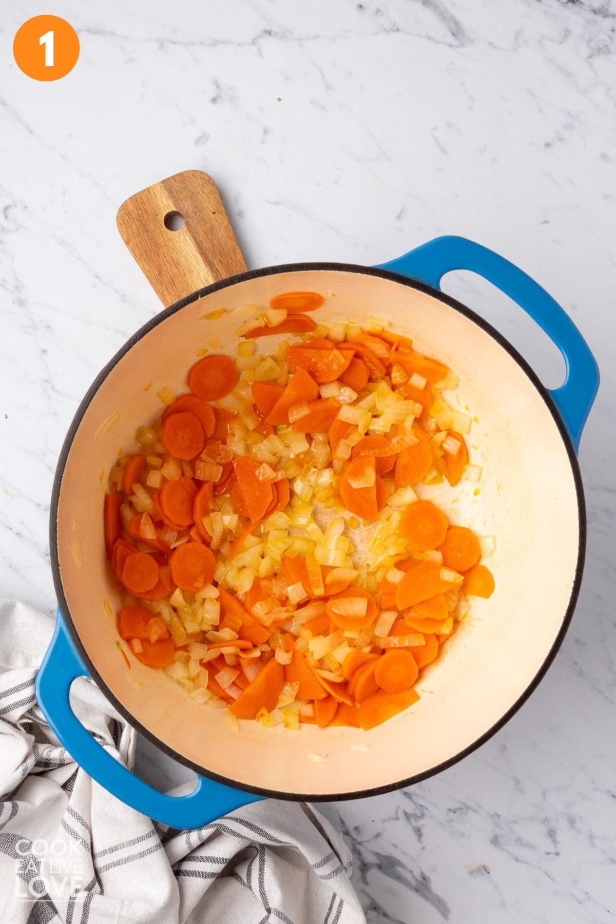 Cooking the carrots and onion in a large pot. 
