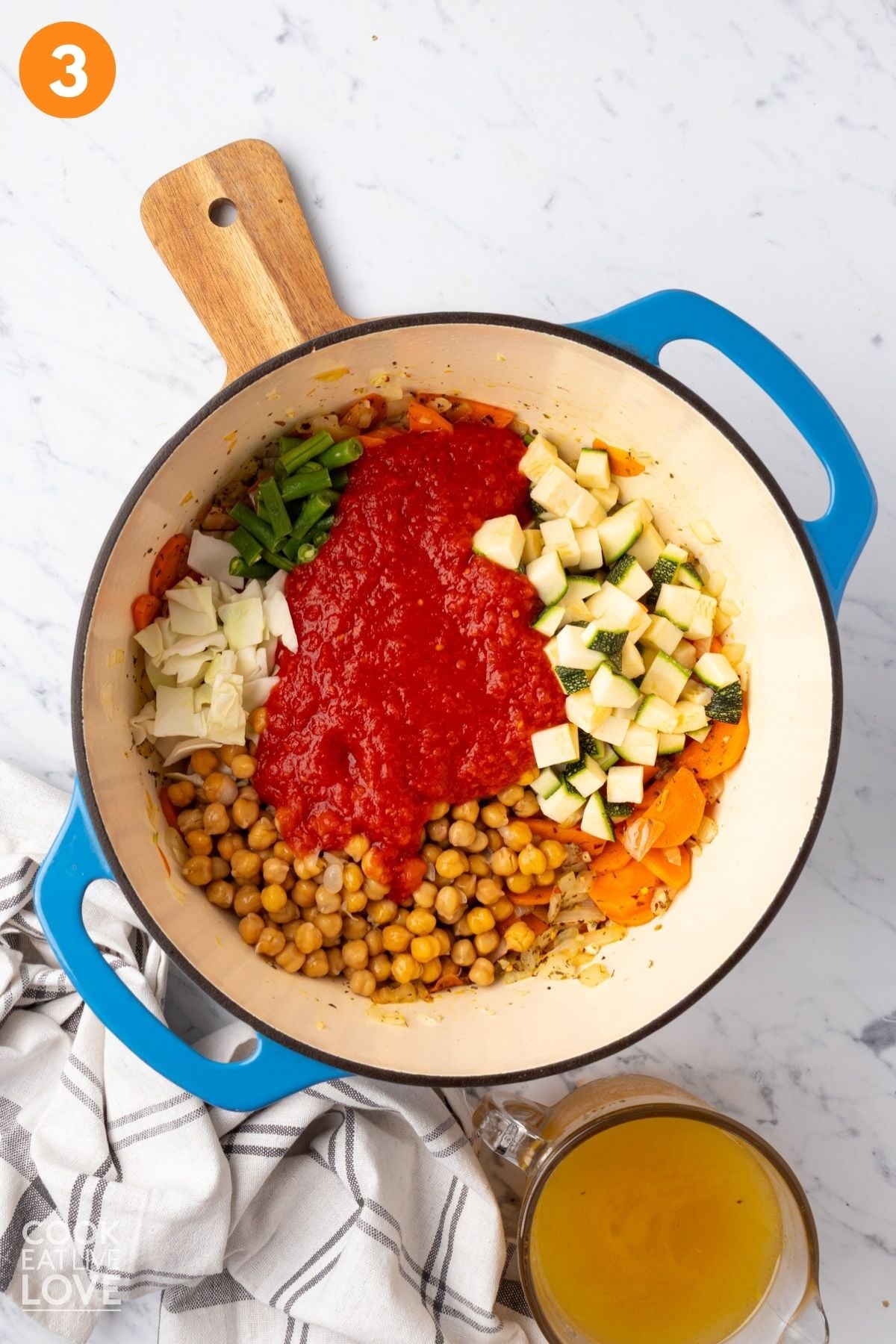 Vegetables and canned tomatoes to the pot of veggies. 