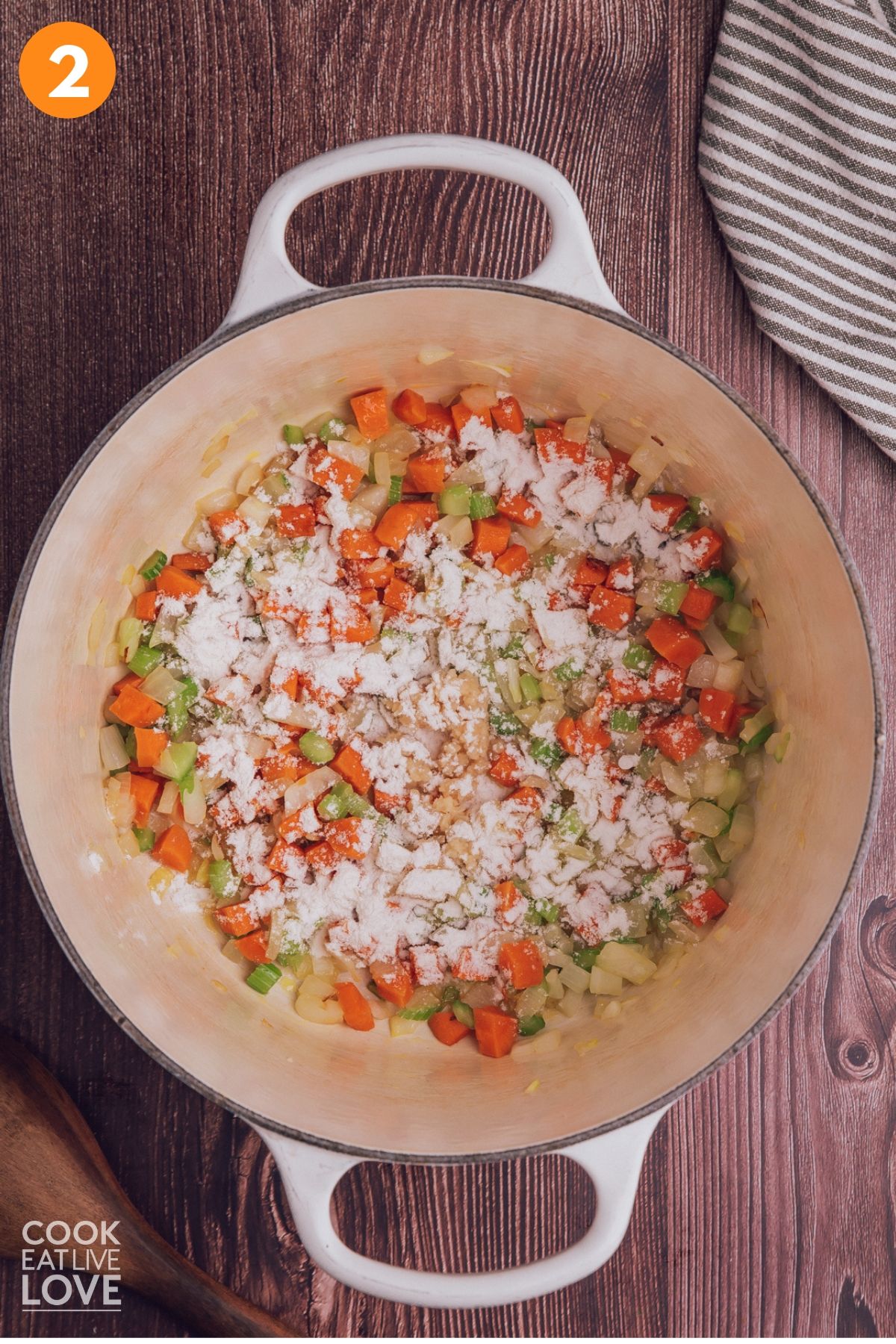 Flour added to the pot of sauteed veggies. 